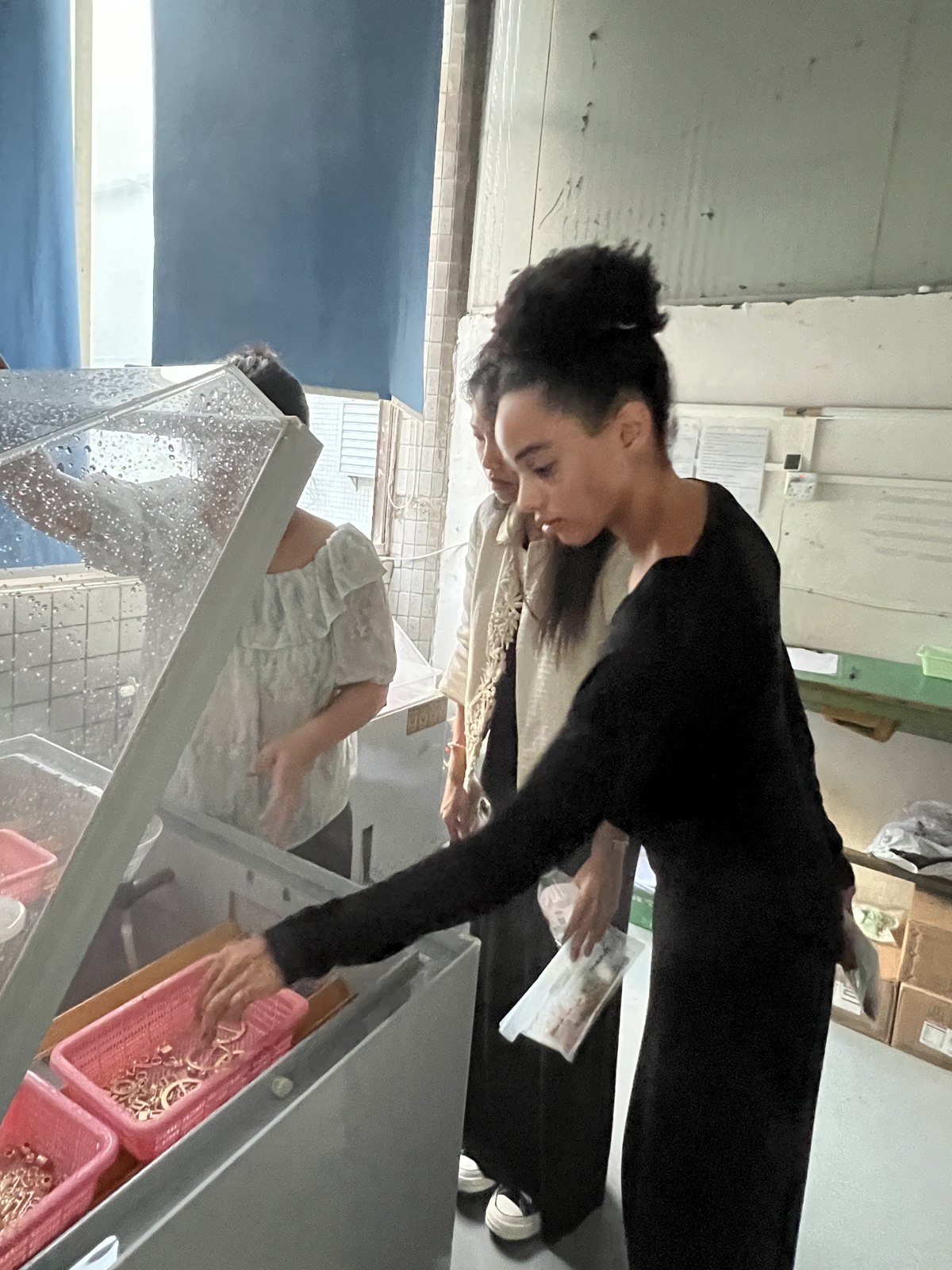Retrieving accessory samples from a salt spray test chamber at SANYE’s testing laboratory.